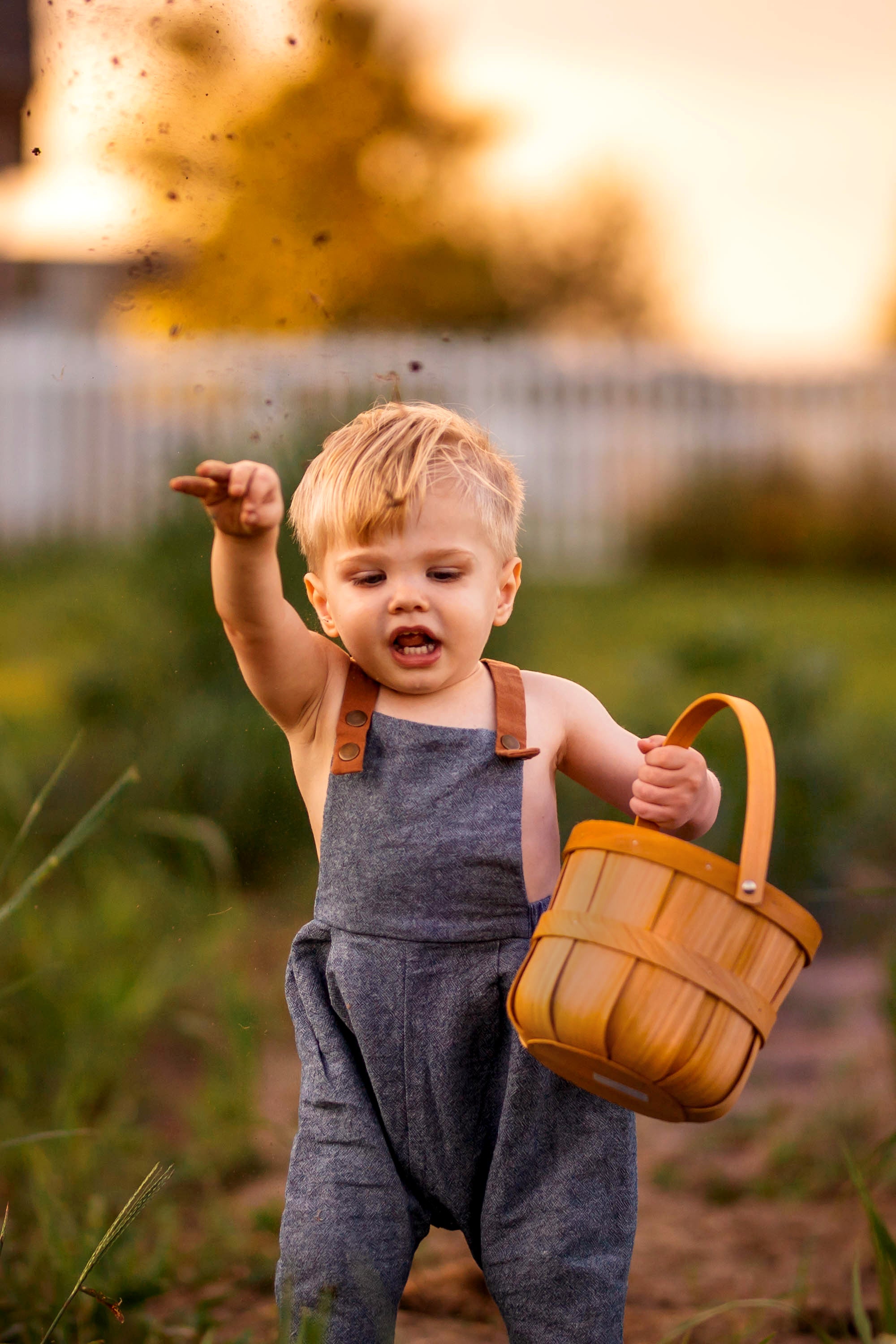 Model Playing with Soil in Chambray Blue Linen Long Overalls: An 18-month-old model is shown wearing the Chambray Blue Long Overalls while playing with soil, showcasing the breathable fabric that ensures comfort during playful activities.