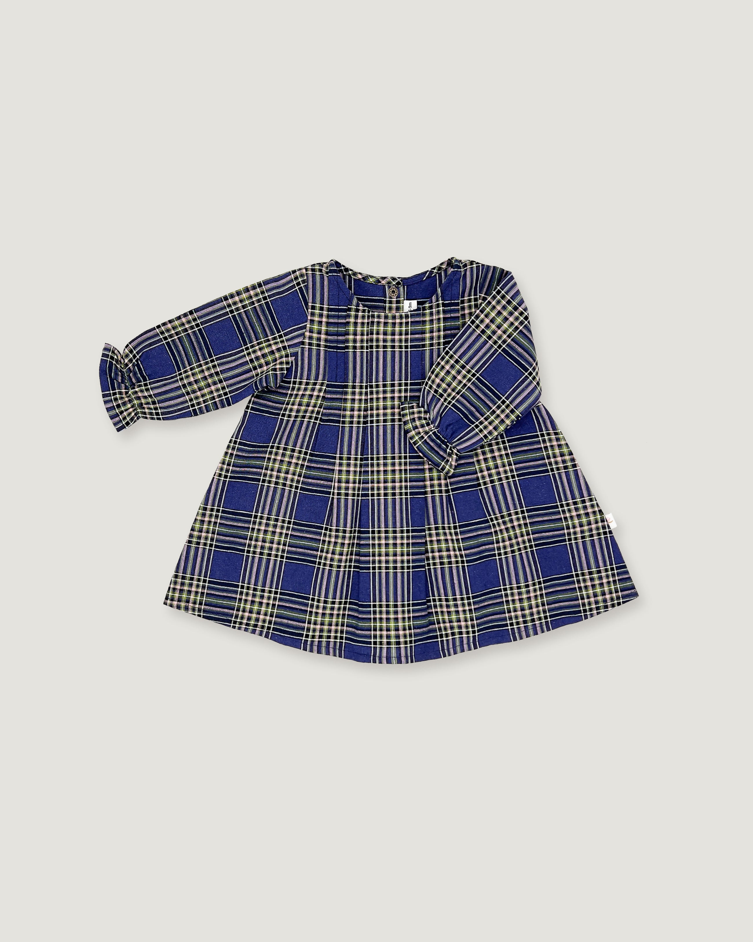 A long-sleeve children's dress with a blue, beige, and white plaid pattern, laid flat on a light gray background.