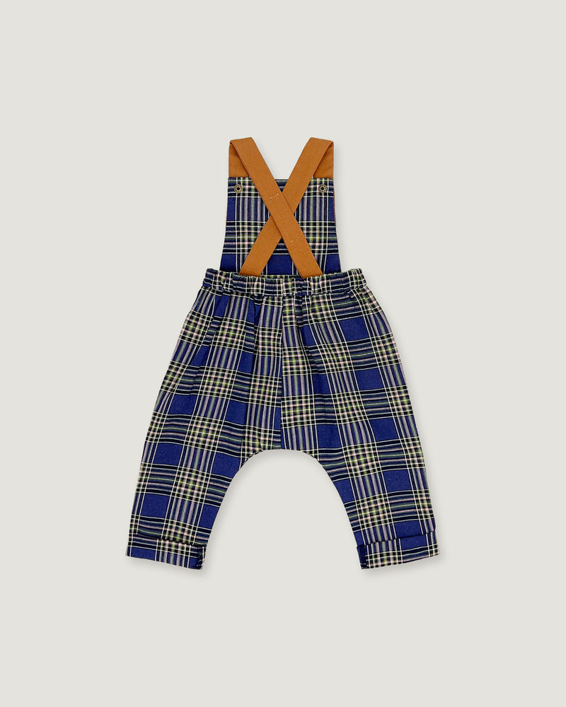 A baby romper with suspenders featuring a blue, beige, and white plaid pattern, with contrasting tan shoulder straps, shown on a light gray background.