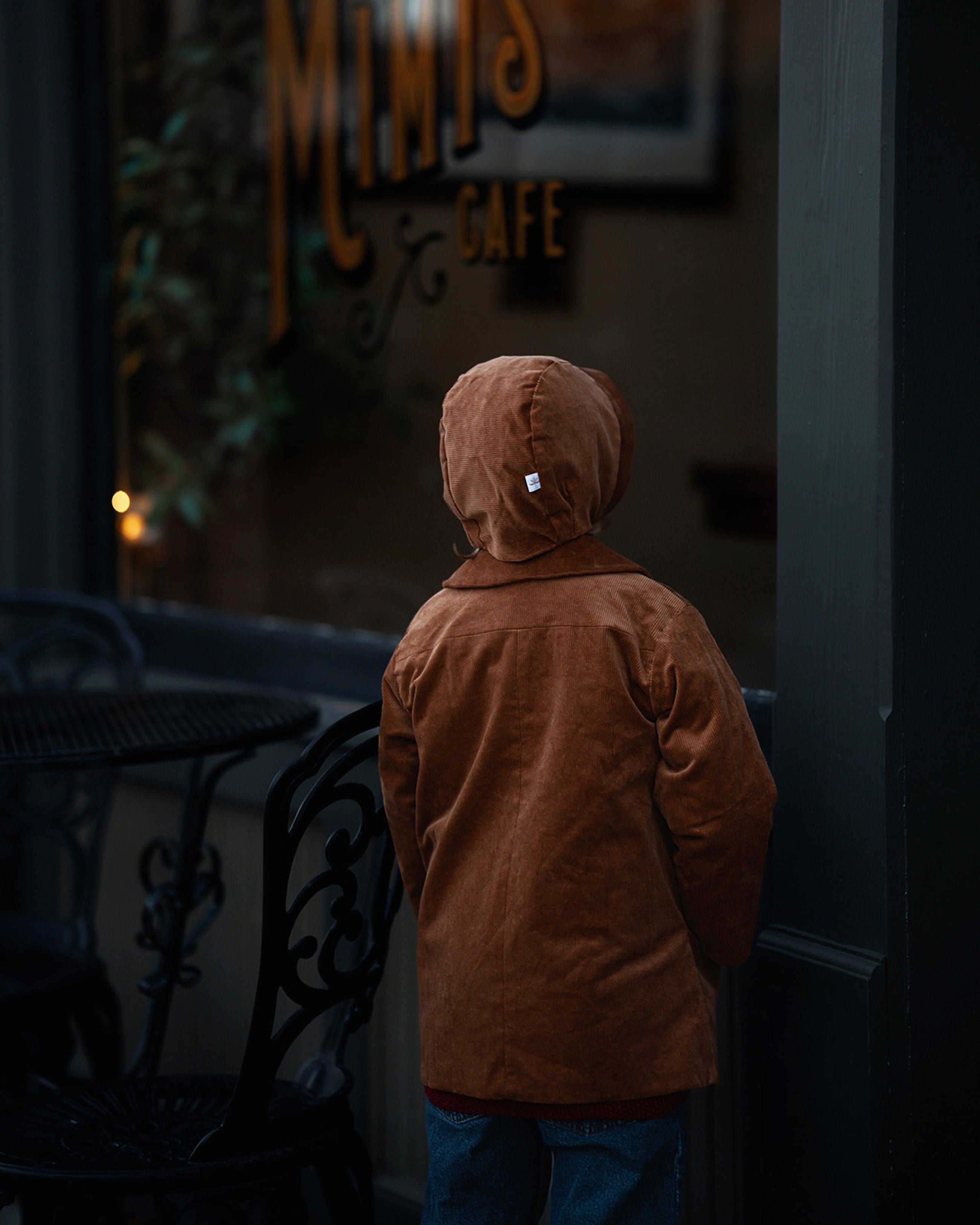 Back View with Bonnet: Back view of little boy in the Camel coat and bonnet, emphasizing the coat’s durability and timeless appeal for eco-conscious families.