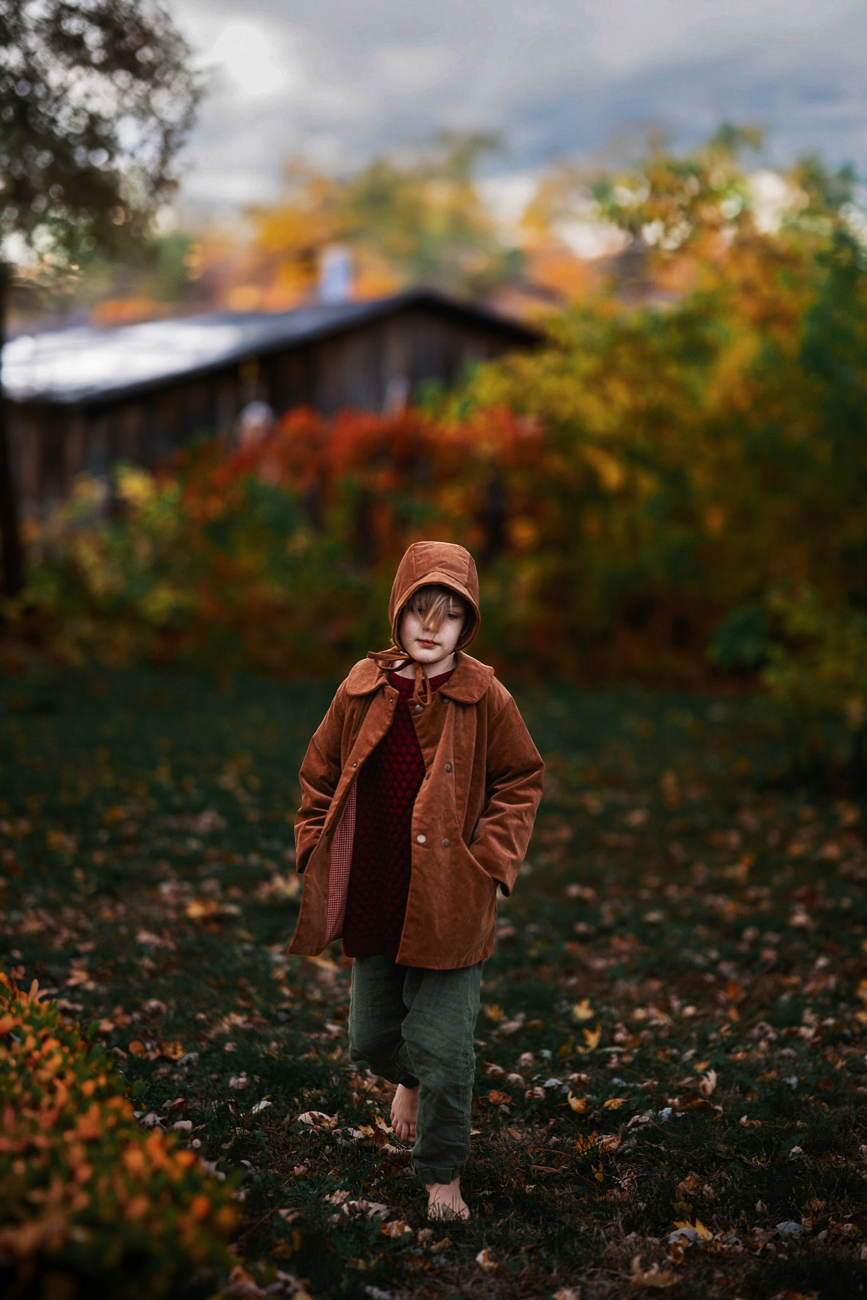 Ezra, a 5-year-old boy model, is captured mid-stride in the Camel coat and matching Camel Corduroy Bonnet, embodying playful energy and style, perfect for active children.