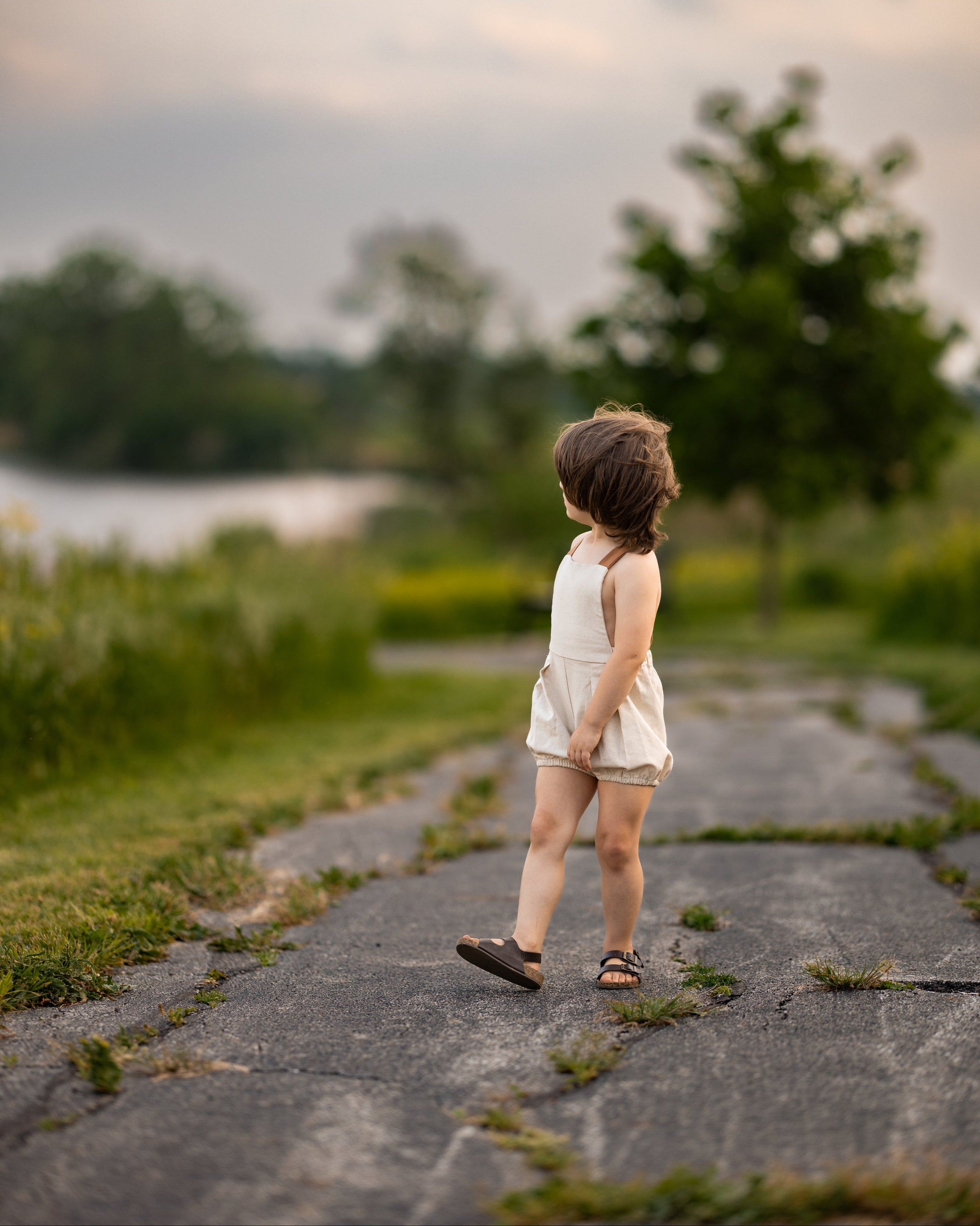 Child walking on a stone path with a natural background