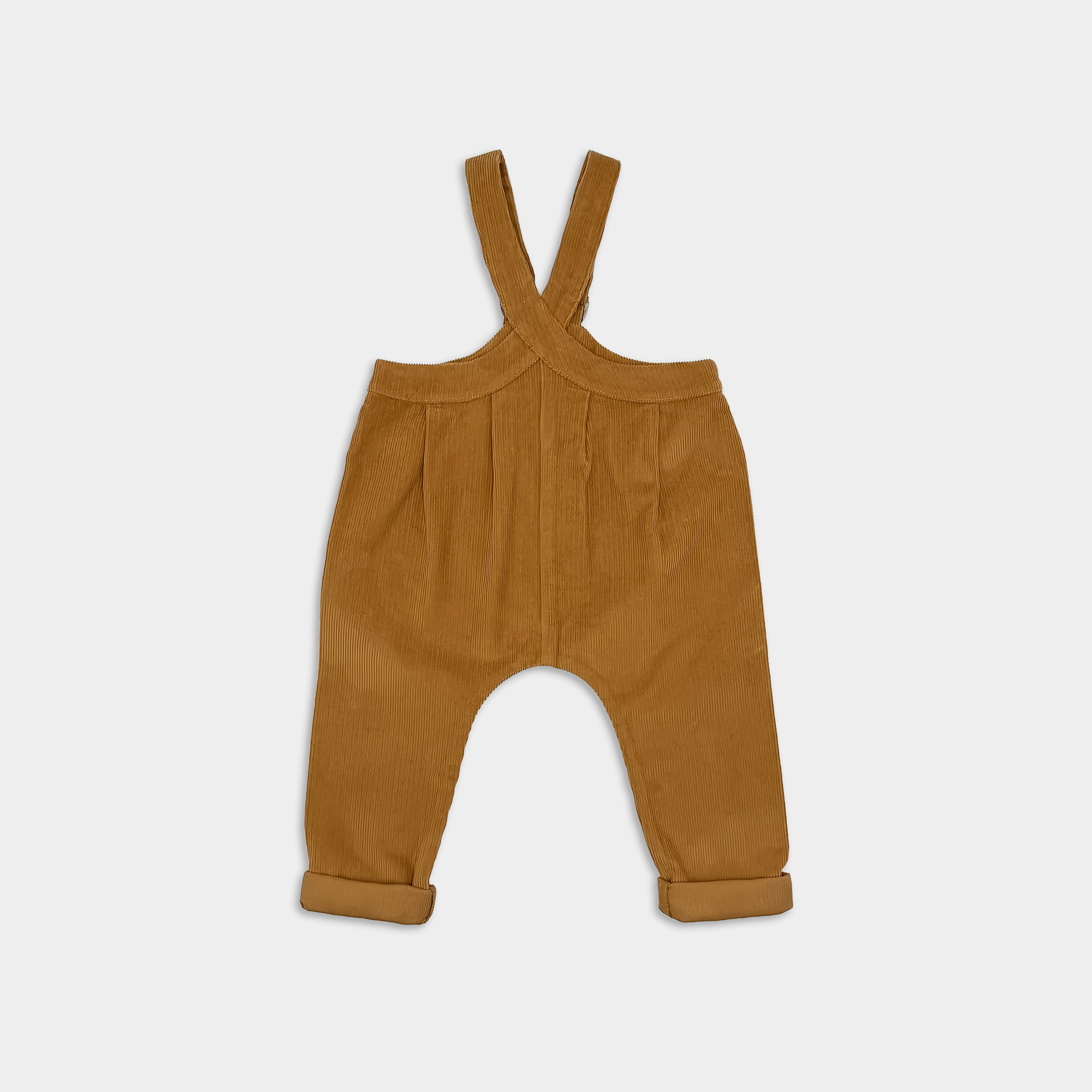 Mustard corduroy overalls on a light gray background