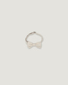 A light cream-colored bow tie with a textured fabric bow and a thin band, shown against a solid light gray background.