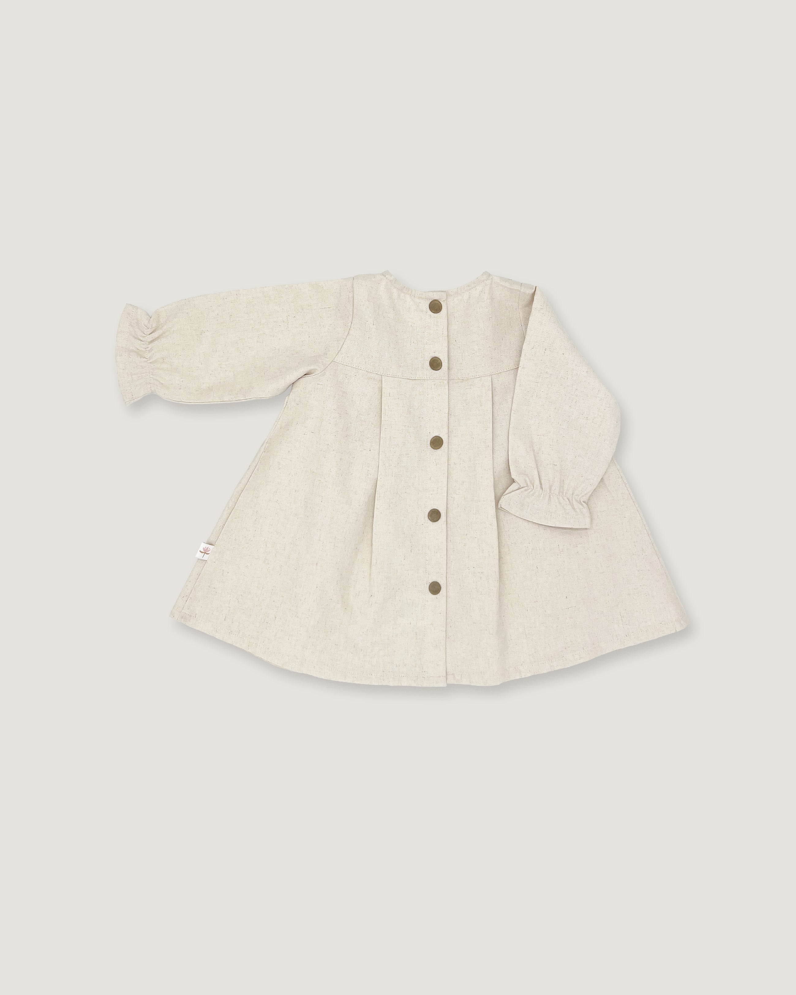 A light beige linen long-sleeve cardigan with a button-up front, pleated details, and ruffled cuffs, shown flat on a neutral light gray background.