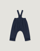A pair of baby boy's navy blue suspenders with a unique curved leg design and cuffed hems, shown flat on a light gray background.