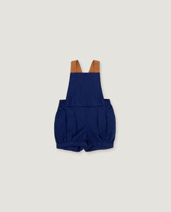 A pair of navy blue baby shorts with adjustable brown shoulder straps, laid flat against a light gray background.