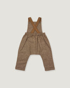 A pair of toddler's brown linen overall pants with adjustable suspenders, laid flat on a light gray background.