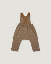 A pair of toddler's brown linen overall pants with adjustable suspenders, laid flat on a light gray background.