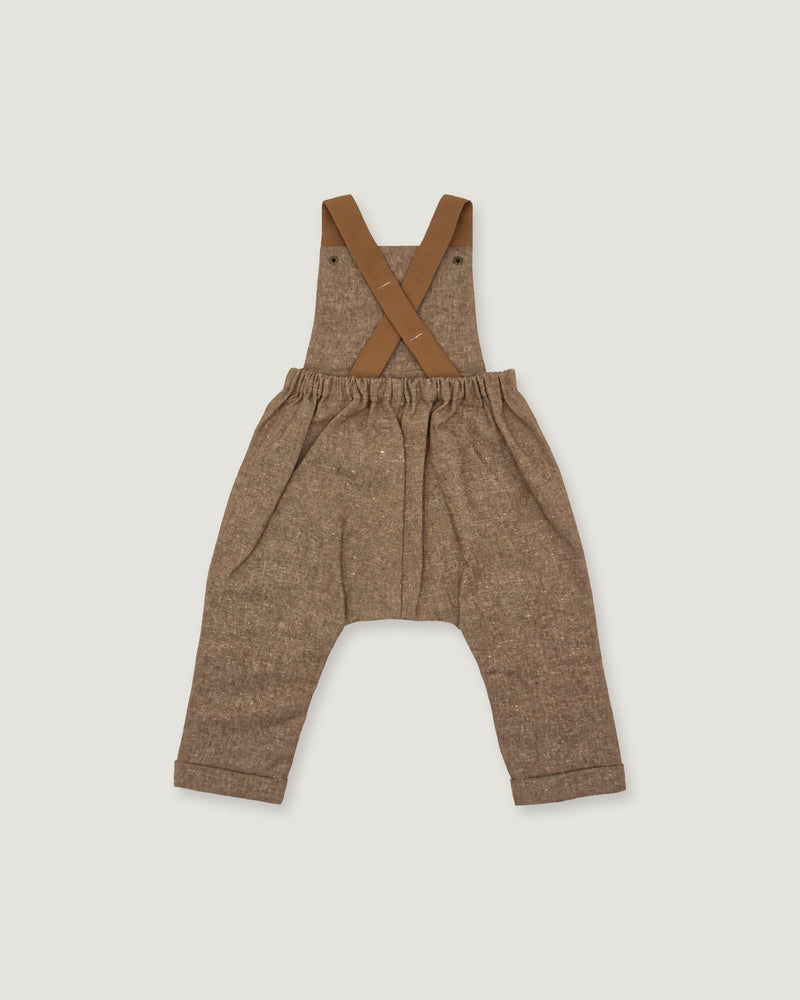 A pair of toddler's brown linen overall pants with adjustable suspenders, laid flat on a light gray background.