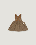 A toddler girl's brown textured linen overall dress with adjustable shoulder straps and a gathered skirt, shown flat on a light gray background.