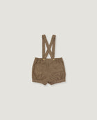 A pair of toddler's brown suspender shorts with a textured woven fabric, laid flat on a light gray background.