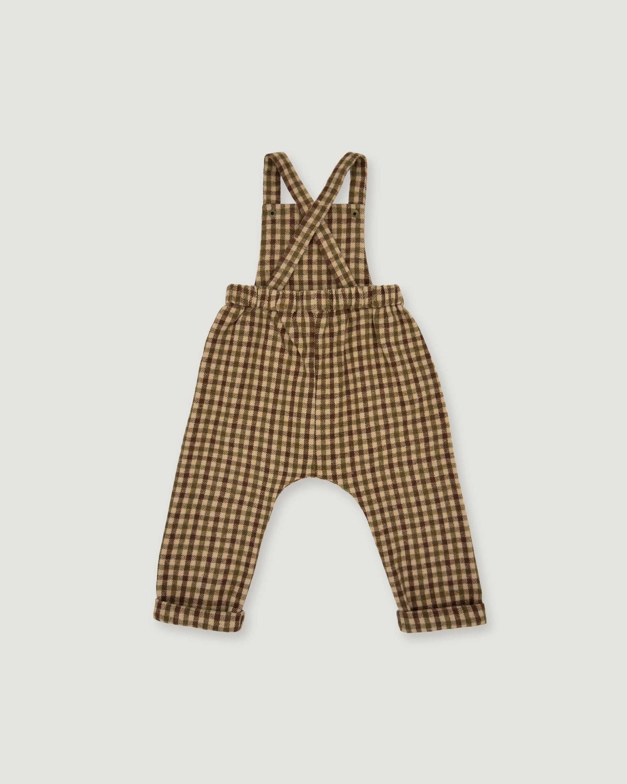 A baby romper with suspenders in a brown and beige gingham check pattern, laid flat on a light gray background.