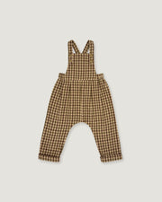 A baby romper with brown and beige gingham check print, featuring shoulder straps and a wide leg design, shown flat on a light gray background.