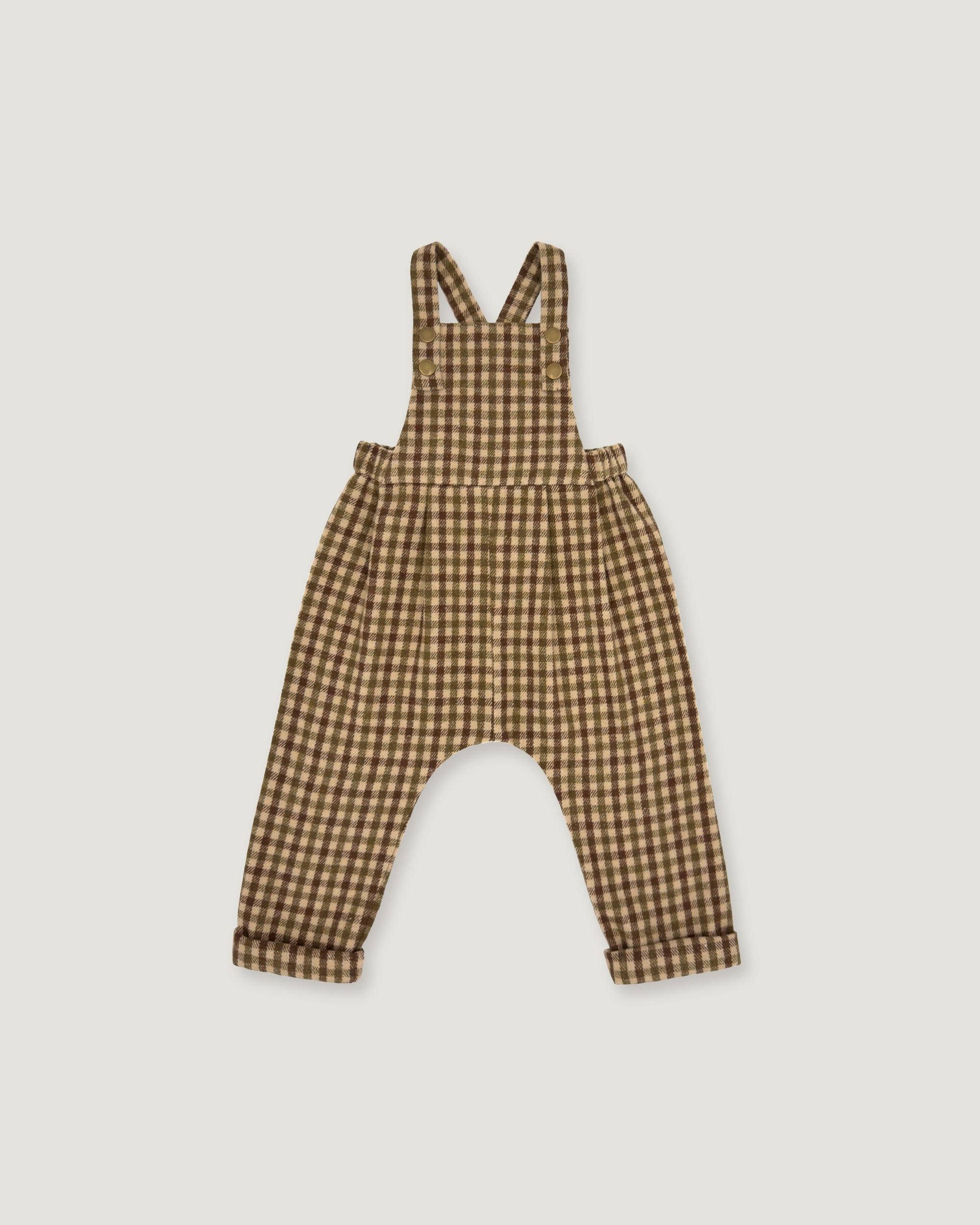 A baby romper with brown and beige gingham check print, featuring shoulder straps and a wide leg design, shown flat on a light gray background.
