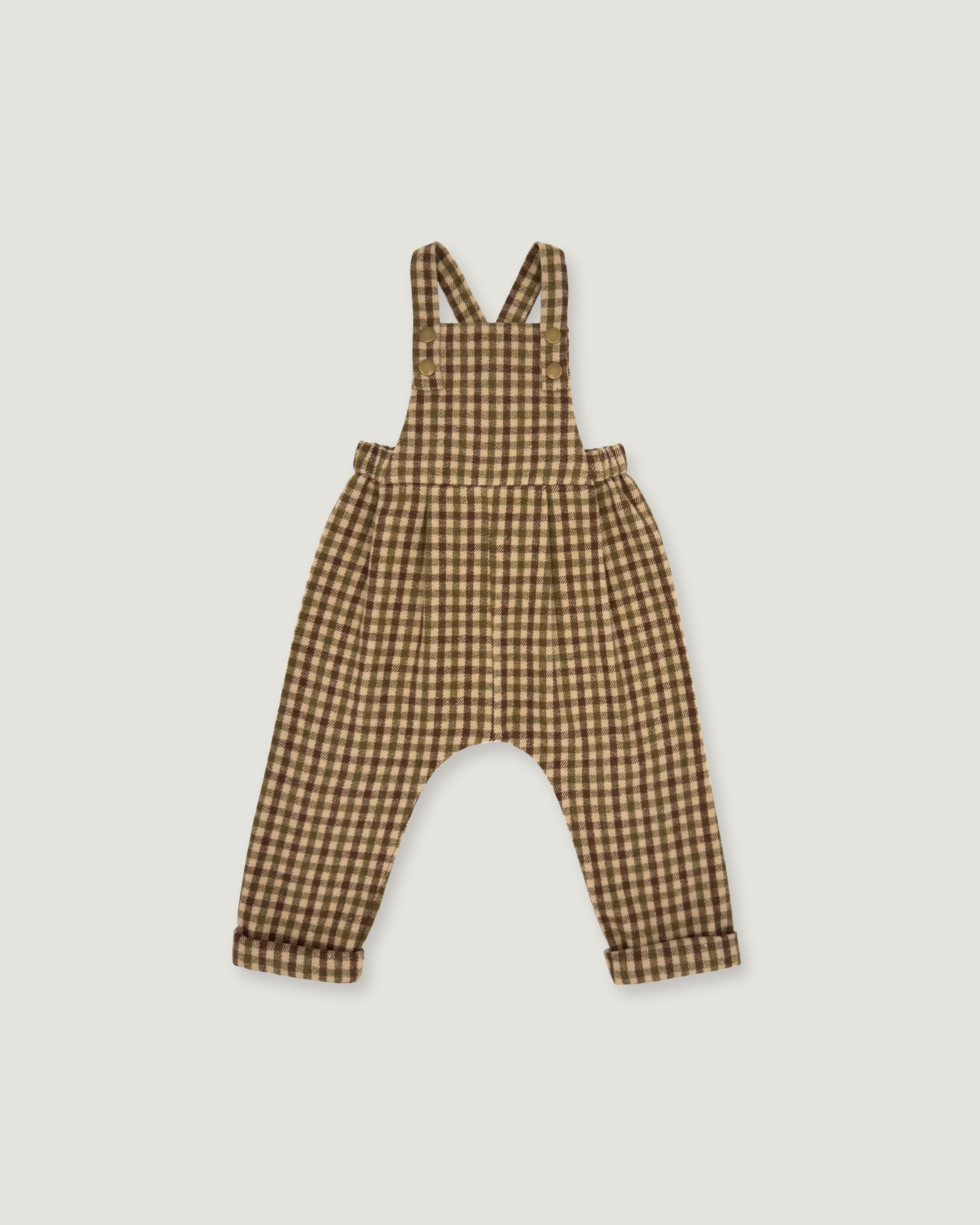 A baby romper with brown and beige gingham check print, featuring shoulder straps and a wide leg design, shown flat on a light gray background.