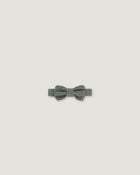A small gray bow tie with a textured, glittery finish, centered on a solid light gray background.