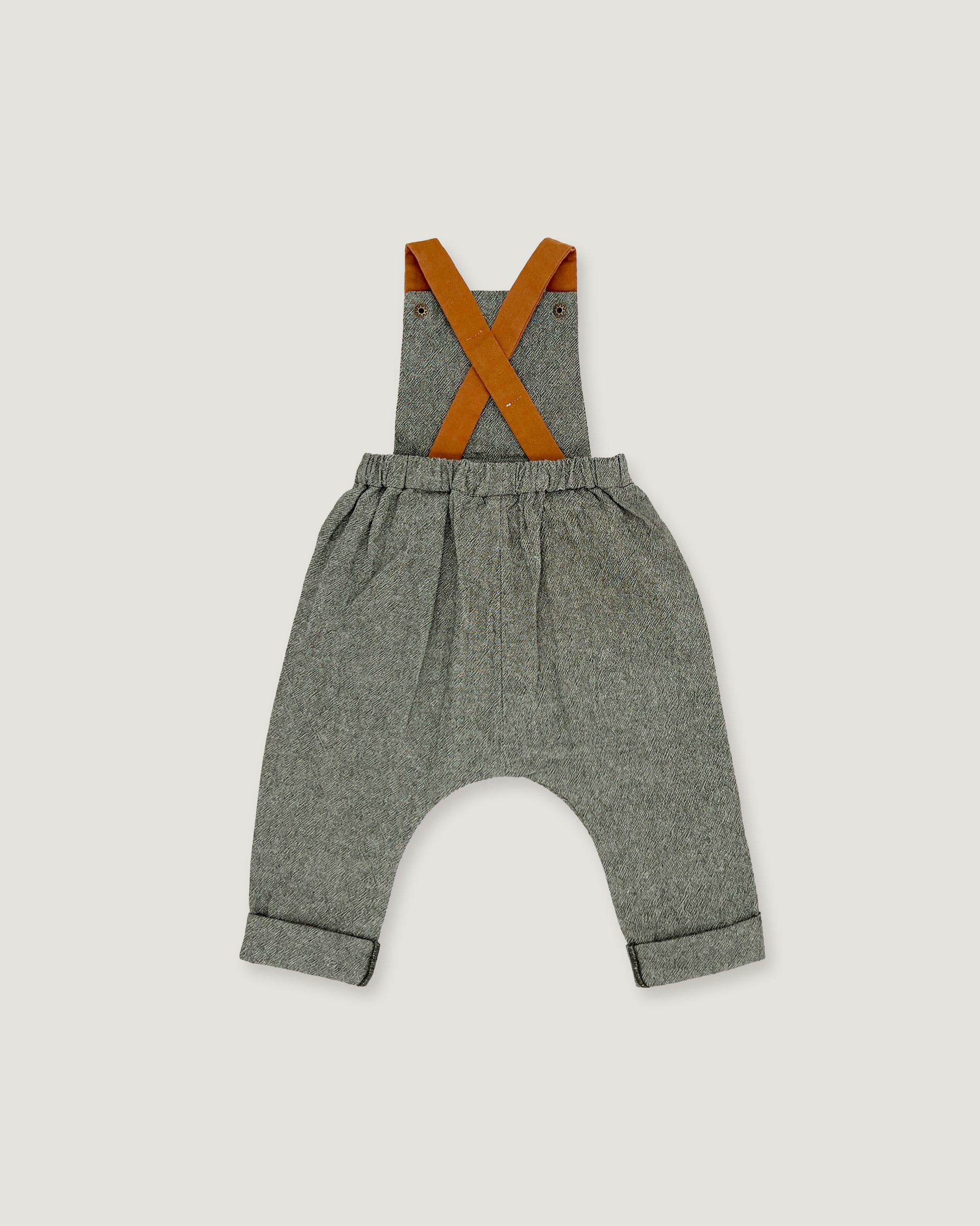 A pair of baby boy's heather gray linen suspenders with contrasting orange-brown leather straps, shown flat on a light gray background.