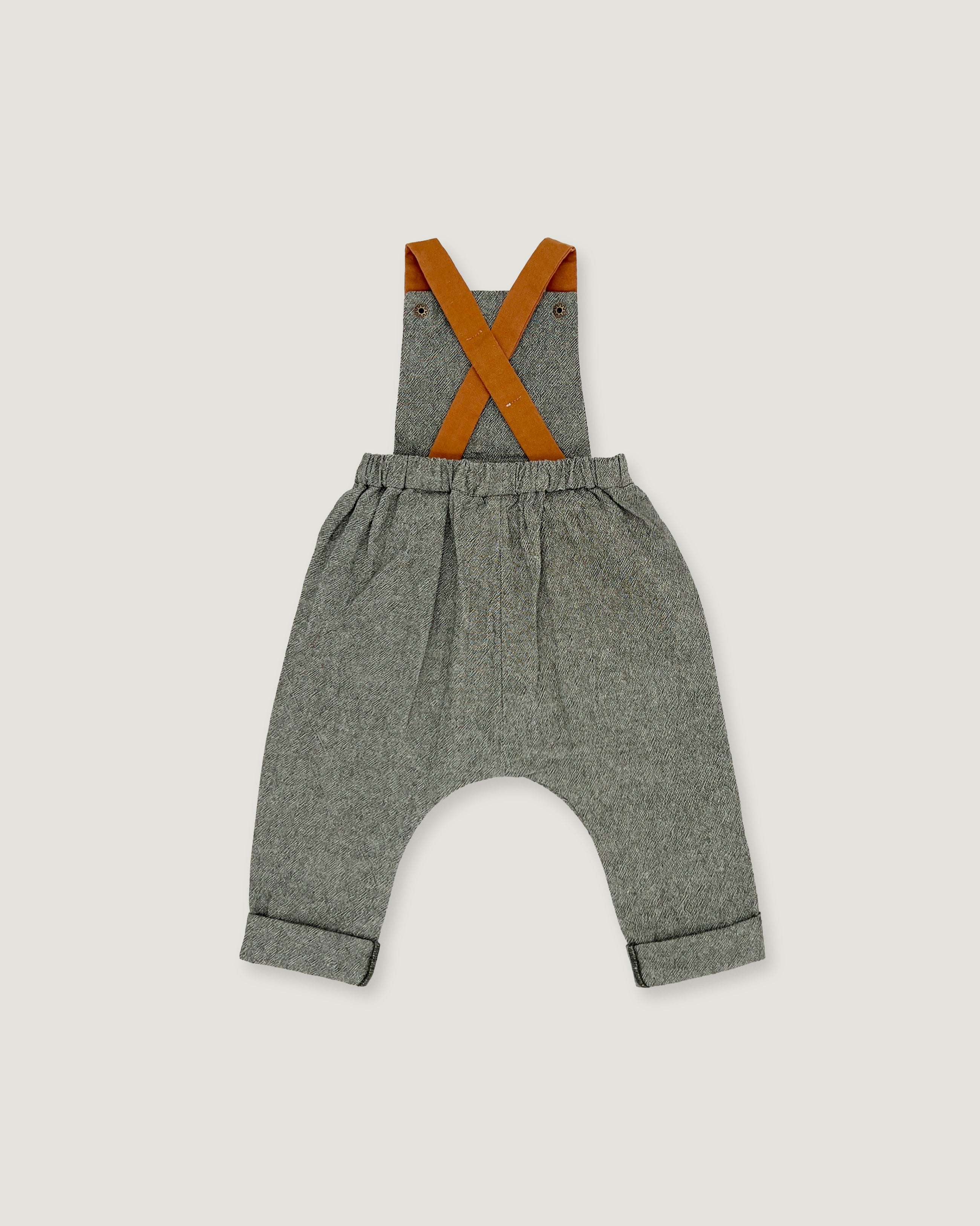 A pair of baby boy's heather gray linen suspenders with contrasting orange-brown leather straps, shown flat on a light gray background.