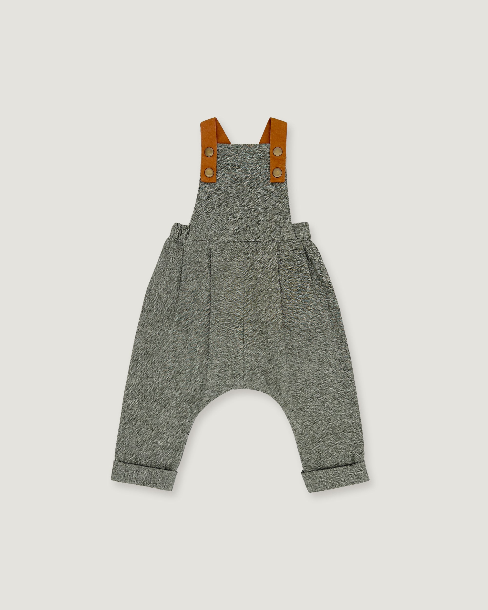 A pair of baby overall pants in heather gray wool, featuring brown leather shoulder straps with snap buttons, shown flat on a light gray background.
