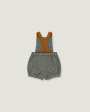 A baby romper with gray textured fabric shorts and brown suspenders, laid flat against a light gray background.
