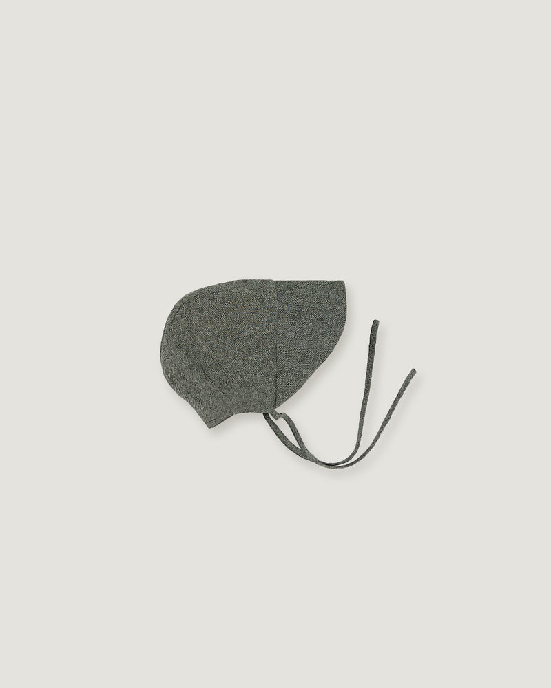 A green linen bonnet with a long visor  on a white background