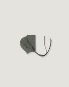 A green linen bonnet with a long visor rolled up  on a white background