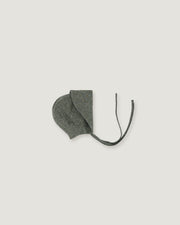 A green linen bonnet with a long visor rolled up  on a white background