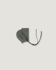 A green linen bonnet with a long visor rolled up  on a white background
