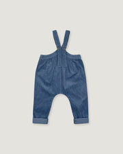 A pair of baby boy's blue corduroy suspenders with a button closure at the waist and rolled cuffs, laid flat on a light gray background.