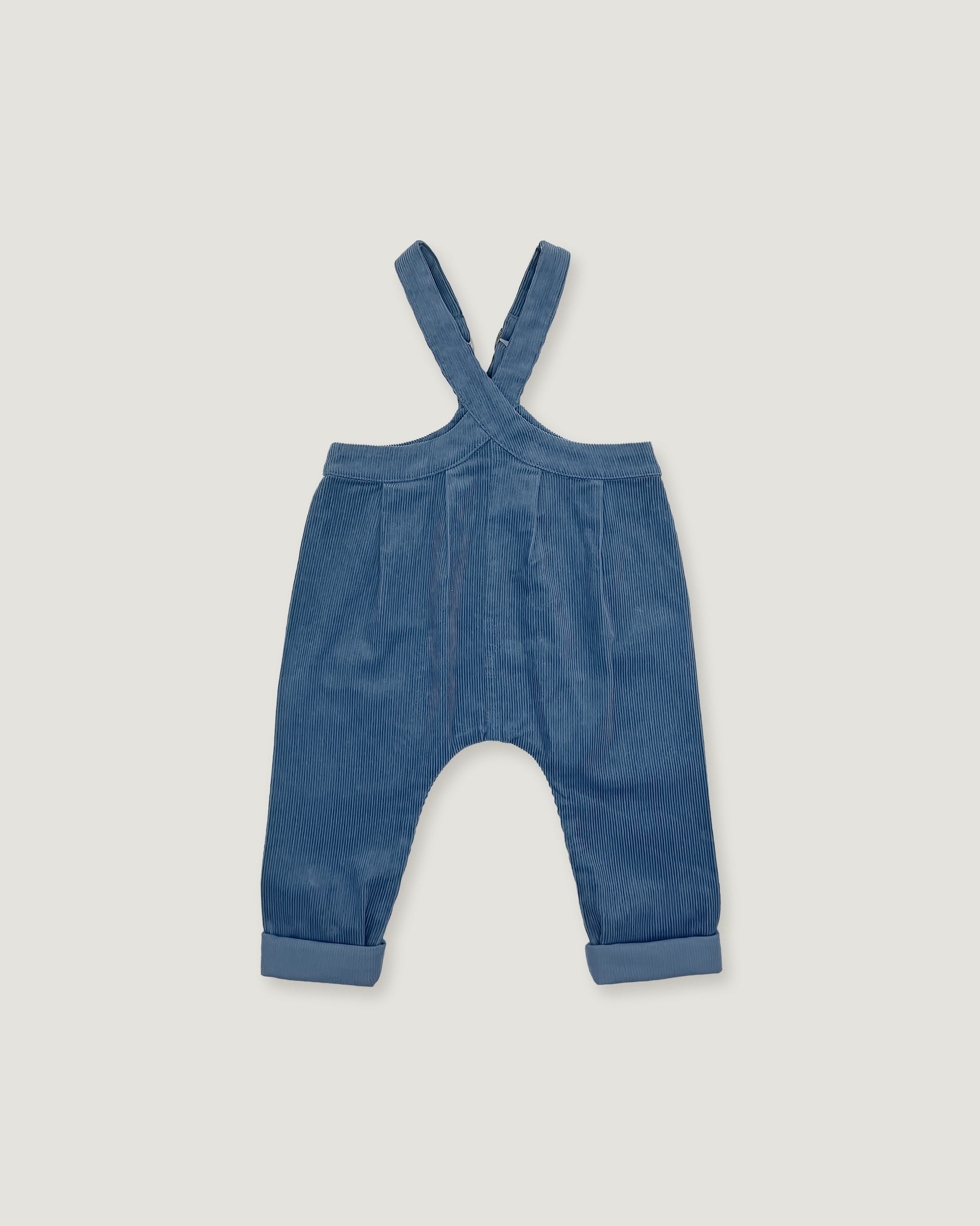 A pair of baby corduroy overalls in a dusty blue color, featuring adjustable shoulder straps and cuffed legs, shown flat on a light gray background.