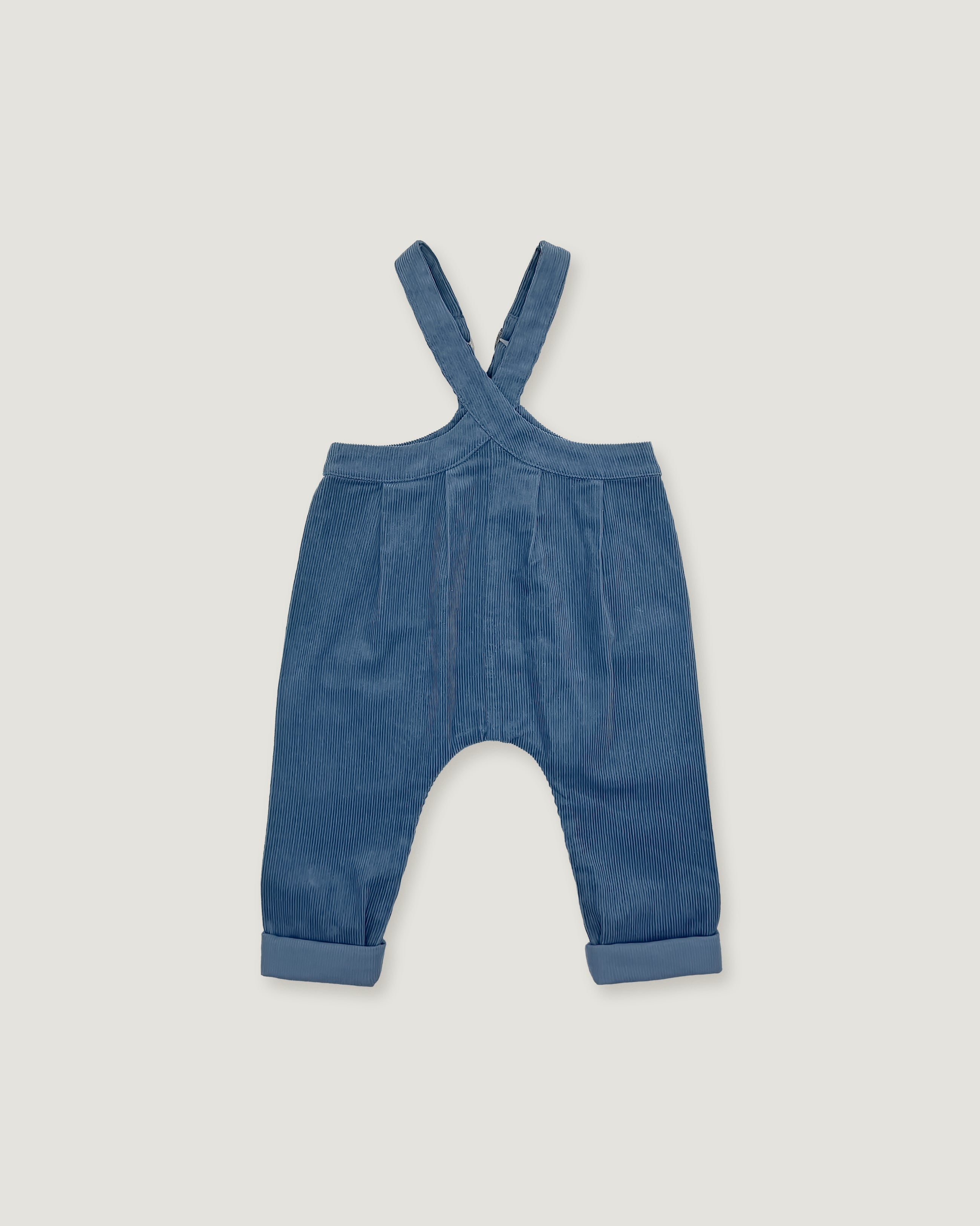 A pair of baby corduroy overalls in a dusty blue color, featuring adjustable shoulder straps and cuffed legs, shown flat on a light gray background.