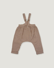 Brown and beige gingham patterned baby overalls with shoulder straps, laid flat on a light gray background.