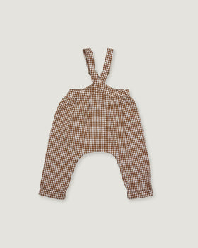 A pair of toddler's harem-style suspenders in a brown and beige gingham pattern, laid flat against a light gray background.