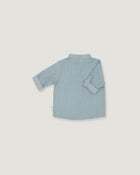 A light blue long-sleeve shirt shown from the back, laid flat on a neutral light gray background.