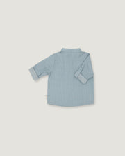 A light blue long-sleeve shirt shown from the back, laid flat on a neutral light gray background.
