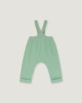 A mint green baby romper with adjustable shoulder straps and a wide leg design, shown flat on a light gray background.