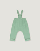 A mint green baby romper with adjustable shoulder straps and a wide leg design, shown flat on a light gray background.