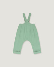A mint green baby romper with adjustable shoulder straps and a wide leg design, shown flat on a light gray background.