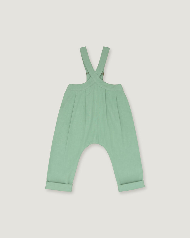 A mint green baby romper with adjustable shoulder straps and a wide leg design, shown flat on a light gray background.