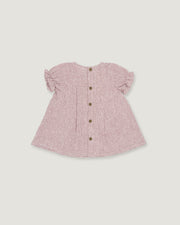 A pink and white gingham baby top with short ruffled sleeves and a button-up front, shown flat on a light gray background.