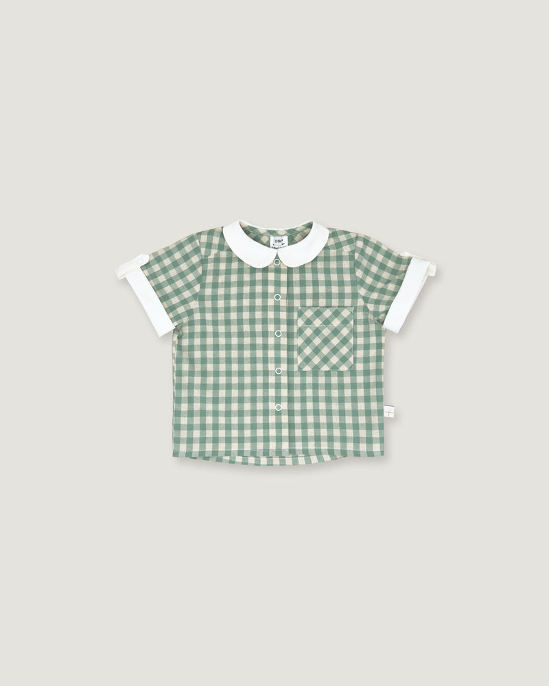 A baby short-sleeve button-up shirt in a green and white gingham pattern, featuring a white Peter Pan collar and white ruffled cuffs, laid flat on a light gray background.