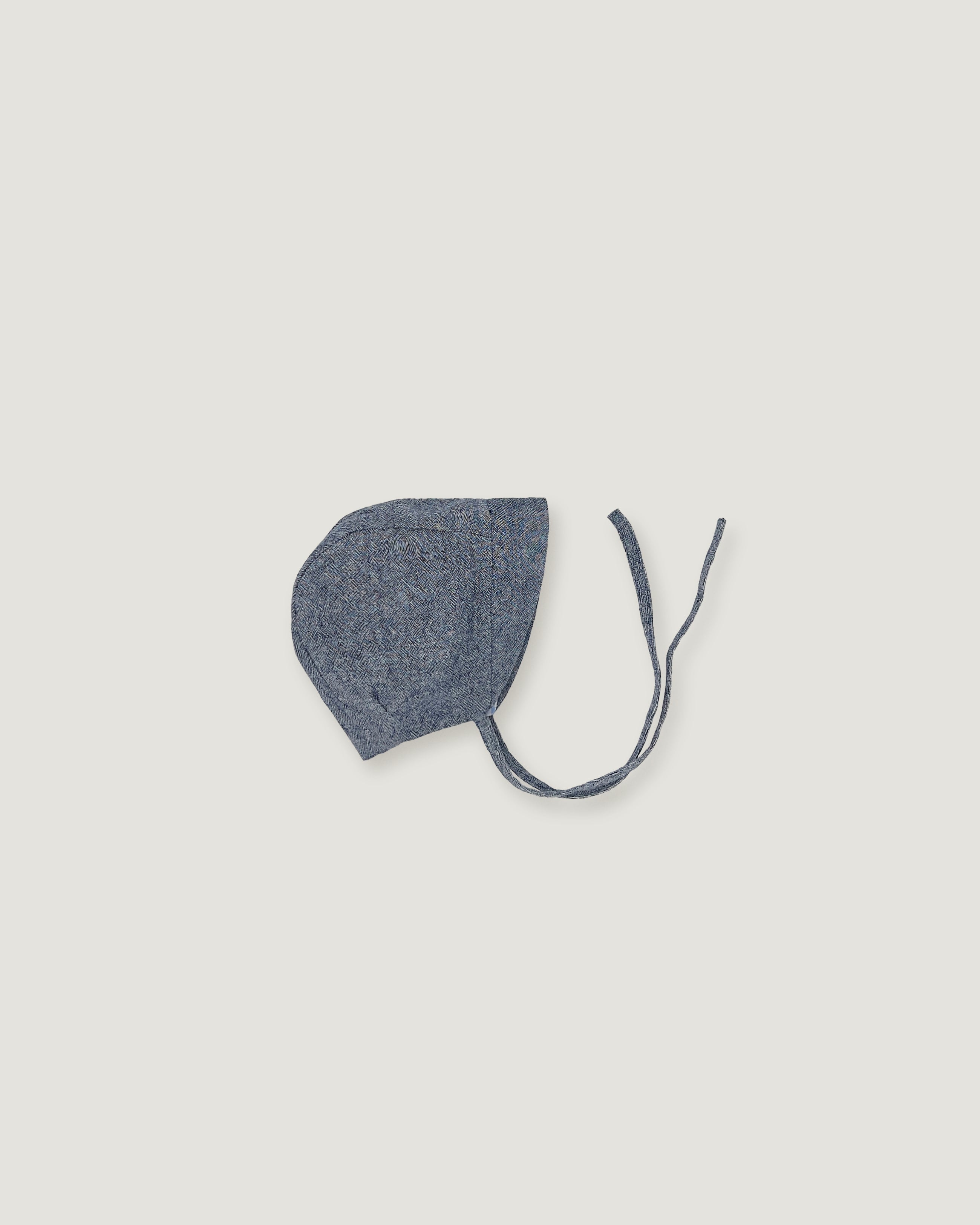 Blue linen bonnet for children with a visor  on a white background