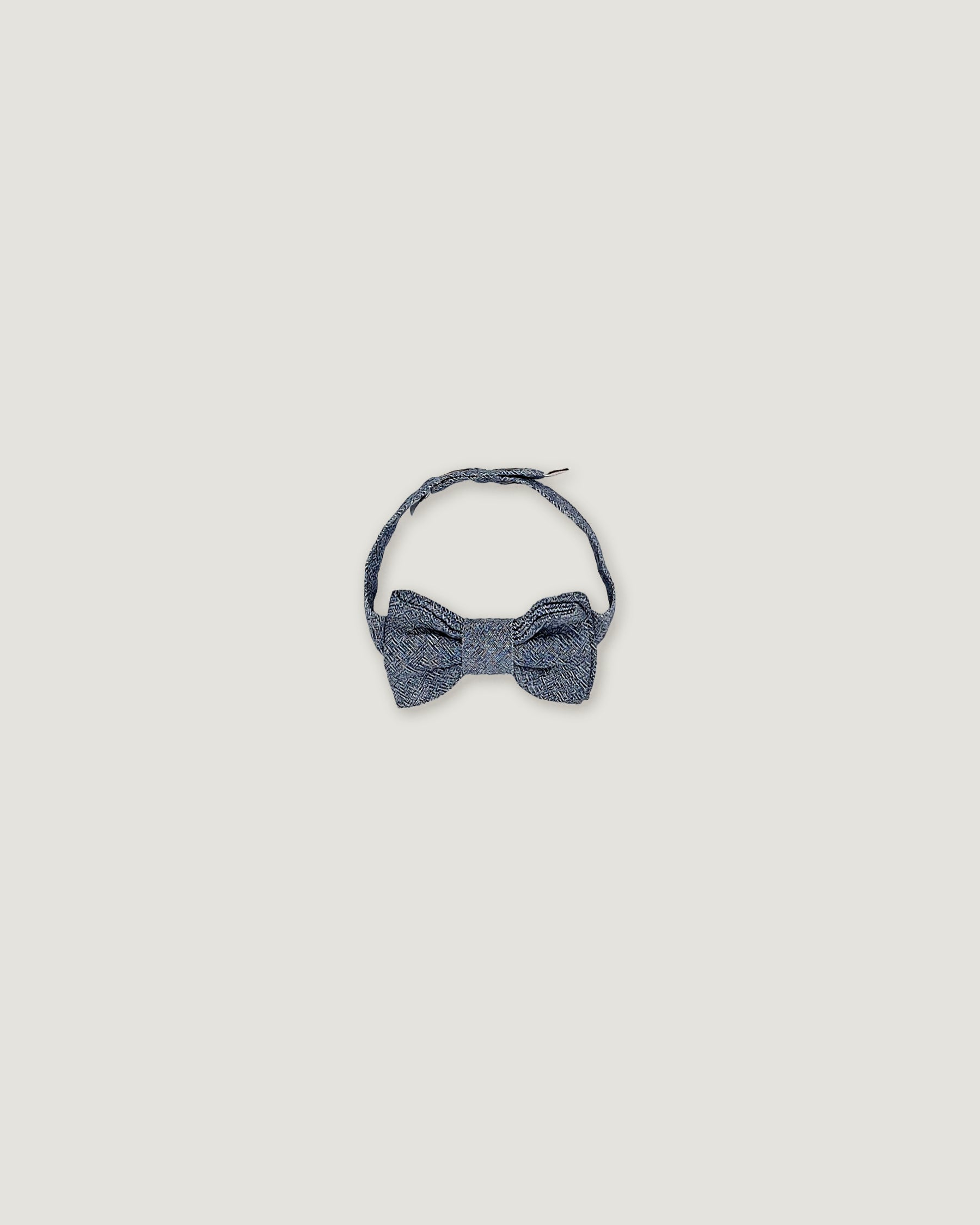 Bow tie for boys in a denim blue over a white background
