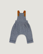 A baby romper in heathered blue-gray fabric with brown shoulder straps, laid flat on a light beige background.