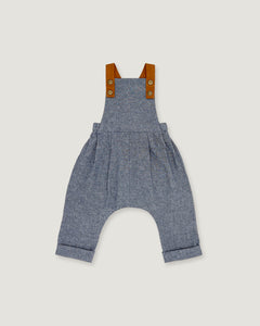 A baby romper in heathered blue-gray fabric with brown shoulder straps, laid flat on a light beige background.