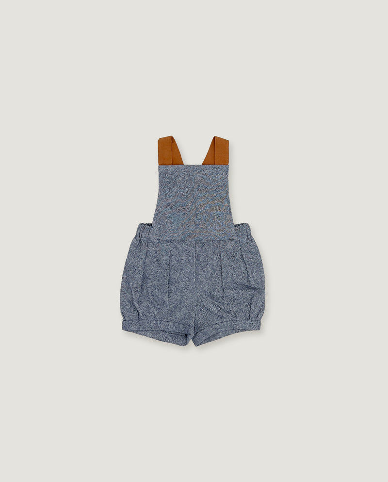 A baby romper in heathered blue-gray fabric with brown shoulder straps, shown flat against a light beige background.