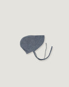 A denim blue linen bonnet with a long visor on a white background