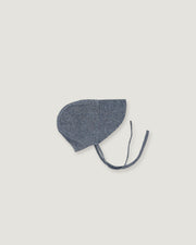 A denim blue linen bonnet with a long visor on a white background