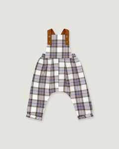A pair of baby overalls featuring a white, blue, and red plaid pattern, with brown adjustable shoulder straps, shown flat on a light gray background.